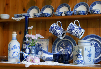 Welsh dresser with clutter of blue and white chinbna