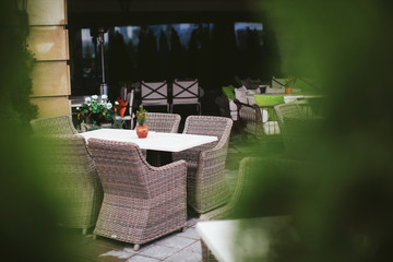 Fototapeta premium empty street restaurant with wicker furniture