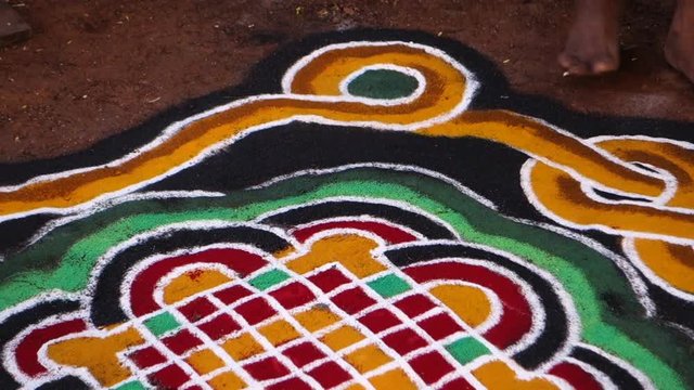 The brahmana doing a rangoli for the ritual installation of the divinity of Ananta Sesha