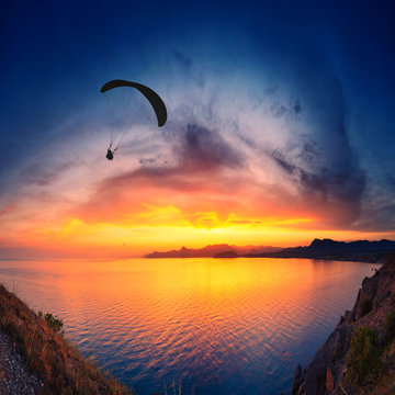 Paraglide above the sea sunset