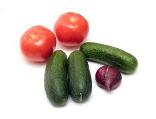 Fresh vegetables isolated on white. Cucumbers, tomatoes and onion top view closeup