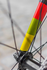 macro detail of a coloured fixie bike fork