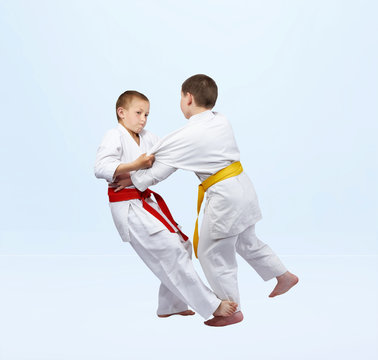 Boys in judo are training capture for throw