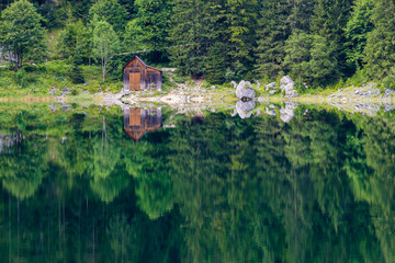 Fototapeta na wymiar Lonely hut at the shore of lake
