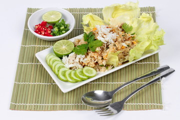 Fried rice with crab topped streamed crab,halve green lemon,sliced cucumber,lettuce and coriander  served  spicy  sour filling side dish. Side view.