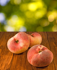 image of peaches on the table on a green background close up