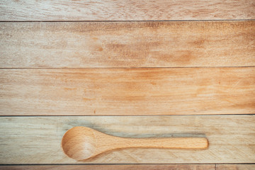 wooden spoon with wooden background