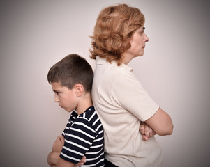 Angry mother and son turning their backs to each other