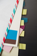 Envelopes, sticky notes, notepads, and notes all with small market tabs arranged on a chrome background - 121548446