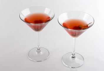 Two full martini glasses. Taken on a white background. 