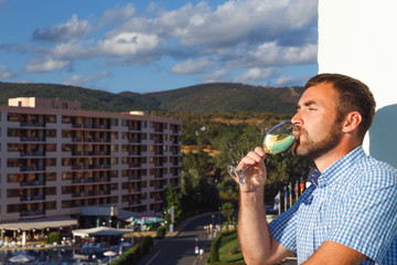 Fototapeta premium handsome guy standing on balcony