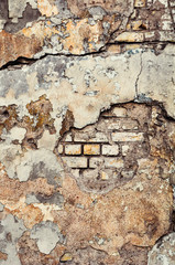 Cracked, heavily damaged brick wall texture background