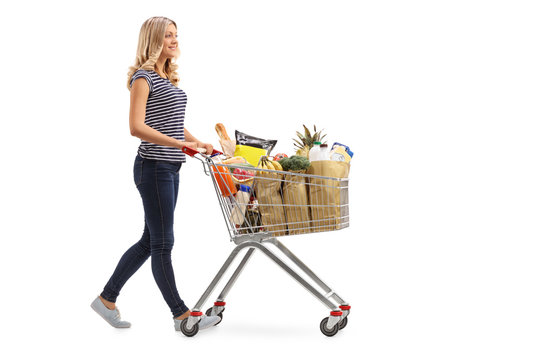 Woman Pushing A Shopping Cart Full Of Groceries