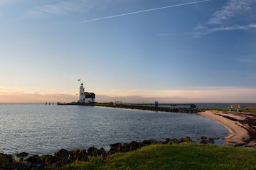 Fototapeta na wymiar White Horse lighthouse of Marken at sunrise, The Netherlands