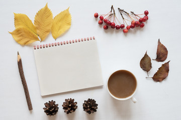 Naklejka na ściany i meble Attributes of autumn, coffee and notebook on a white board