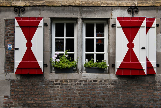 A medieval house in Maastricht with characteristic red & white shutters