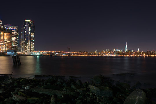 Manhattan illuminated at night, taken from Brooklyn