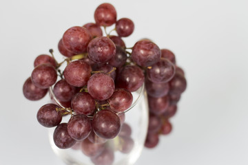 Fototapeta premium red grape on wine glass