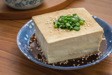 Tofu with soy sauce and sesame on plate