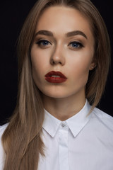 a large portrait of a beautiful young woman in the studio on a b