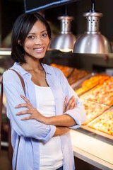 Happy woman standing at food counter