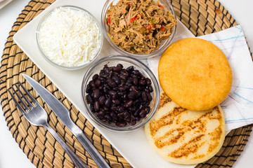 Venezuelan typical food, arepas and their different combinations. Chicken, fish, meat, cheese, black beans and pork.