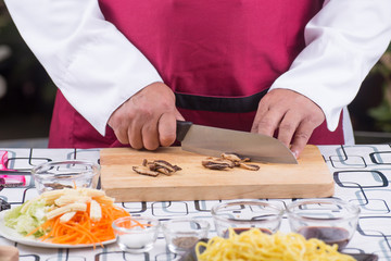 Chef cutting mushroom