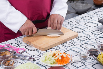 Chef slicing tofu for cooking