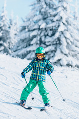 Fototapeta na wymiar Smiling boy on skis