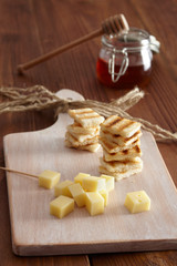 Cheese and honey appetizer, on a chopping board