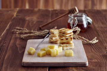 Cheese and honey appetizer, on a chopping board