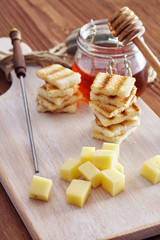 Cheese and honey appetizer, on a chopping board