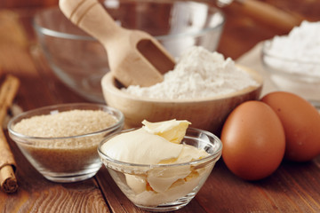 Ingredients to make a cake or a dessert on an aged wooden table