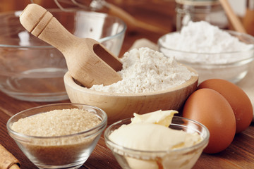 Ingredients to make a cake or a dessert on an aged wooden table