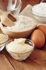 Ingredients to make a cake or a dessert on an aged wooden table