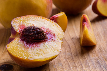 cut peach on wooden table