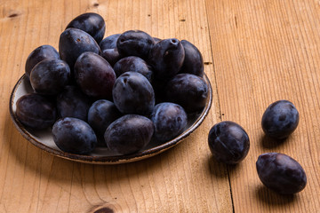 fresh plums on wooden table