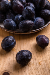 fresh plums on wooden table