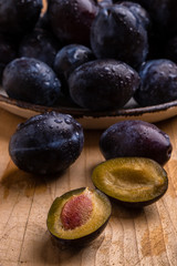 Fototapeta na wymiar fresh plums on wooden table
