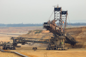 Fototapeta na wymiar Brown coal open pit mine with mining equipment.