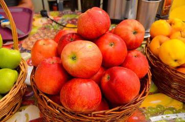 fresh red, green, and yellow apples in wooden basket for sale, Mtskheta Georgia