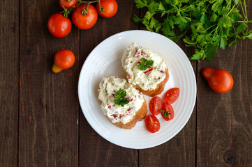 Sandwiches with pate cheese, garlic, slices of pepper, dill. Organic health food. A healthy breakfast. The top view