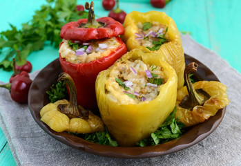 Yellow and red baked peppers stuffed with minced meat and rice.