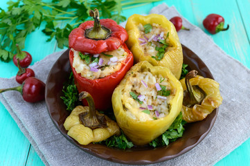 Yellow and red baked peppers stuffed with minced meat and rice.