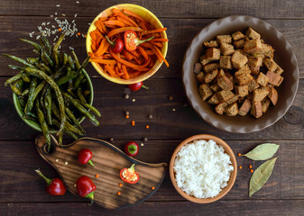Fototapeta premium Baked vegetables (asparagus beans and carrot), boiled rice and rye croutons. Vegetarian cuisine. The top view