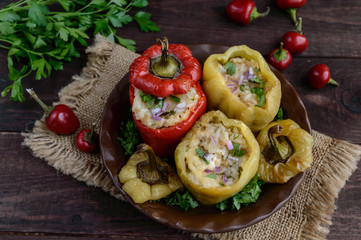 Fototapeta na wymiar Yellow and red baked peppers stuffed with minced meat and rice.