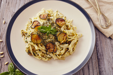 handmade fettuccine pasta with pesto genovese sauce and fried courgette