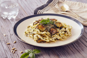 handmade fettuccine pasta with pesto genovese sauce and fried courgette