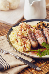 Sausage and mush dish with grilled mushrooms and tomatoes