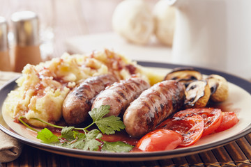 Sausage and mush dish with grilled mushrooms and tomatoes